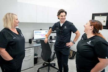 Dr. Baird talking to Millcreek Family Dental team members