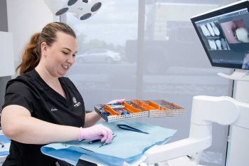 Millcreek Family Dental team member laying out tools next to a dental chair